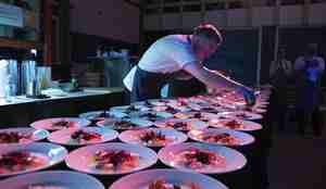 foto av kokk som legger mat på fat