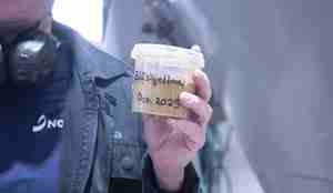 bilder av en boks som inneholder et brunt pulver - blåskjell pulver som skal brukes i laksefôr. blåskjellmel