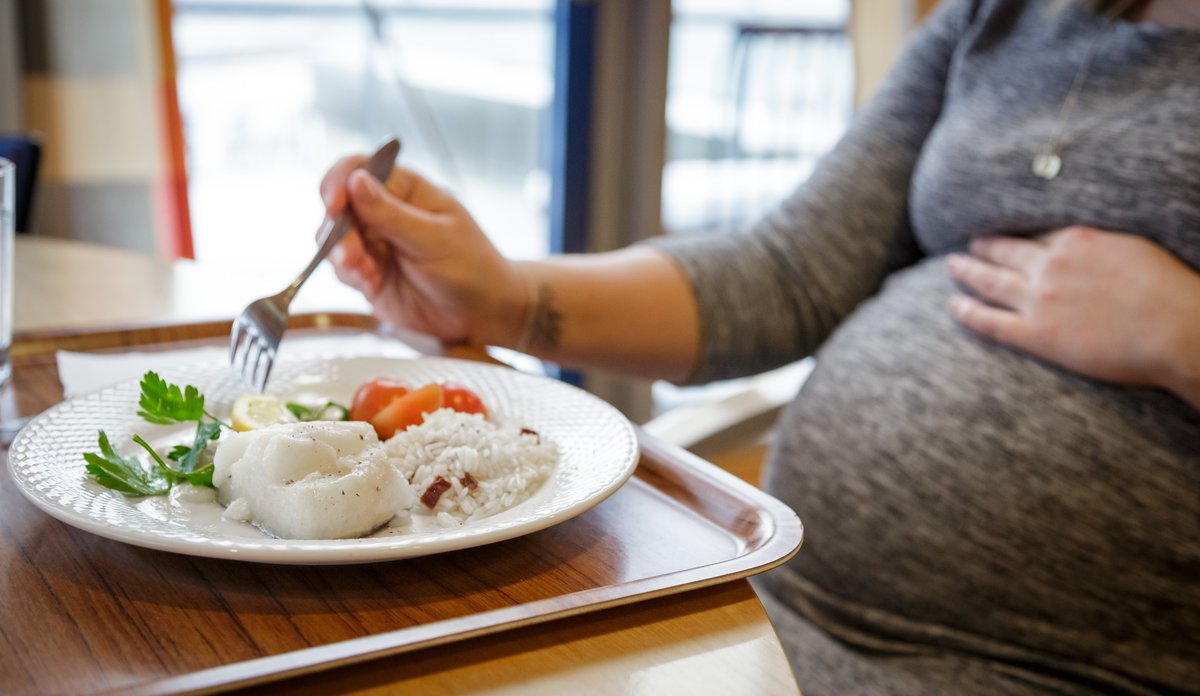 
pregnant woman eating fish