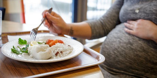 

pregnant woman eating fish