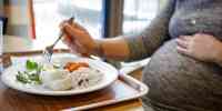 

pregnant woman eating fish