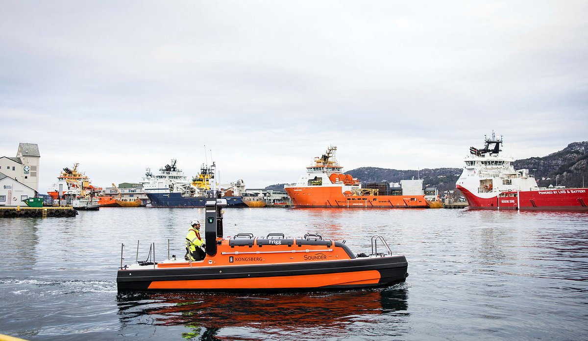 Fjernstyrt farkost i vannet med skip i bakgrunnen.