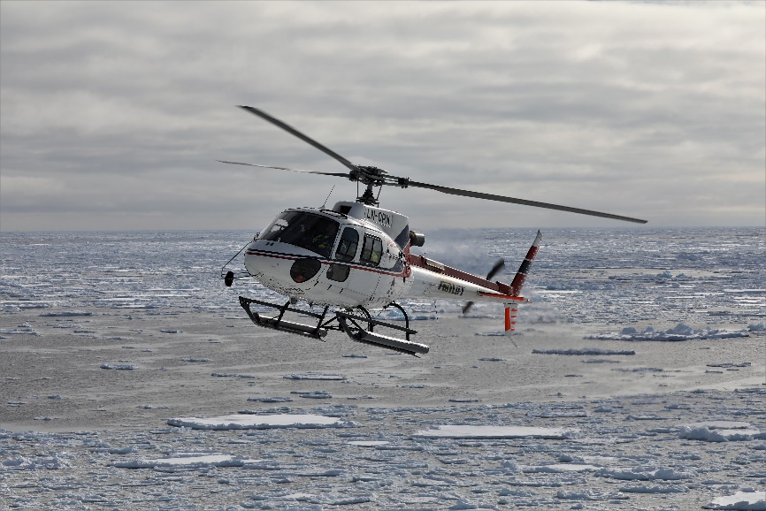 Fig. 2. The helicopter over the Greenland Sea pack ice. (Photo: M. Poltermann)